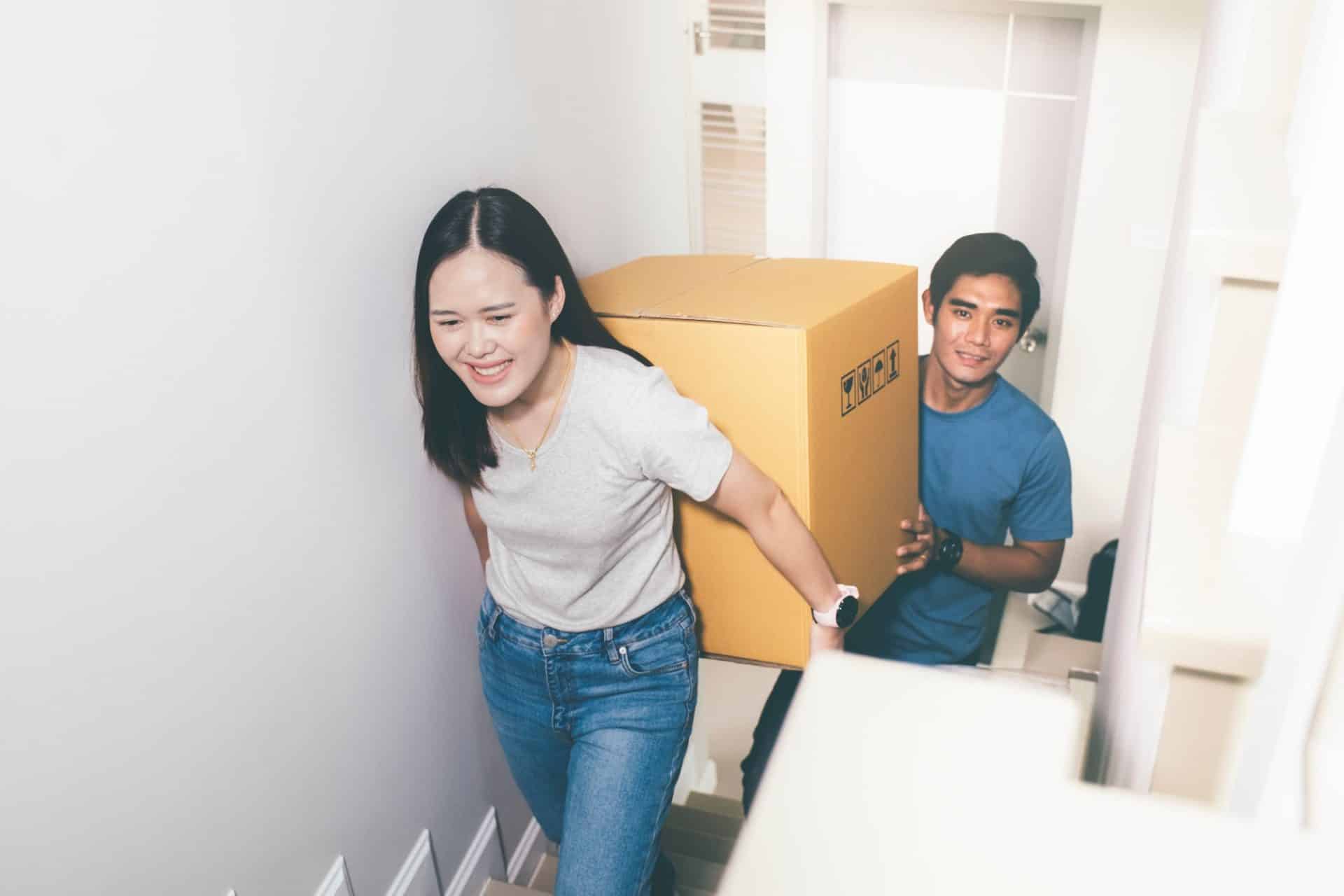 Happy young couple enjoying together moving in a new house. New house at moving day.
