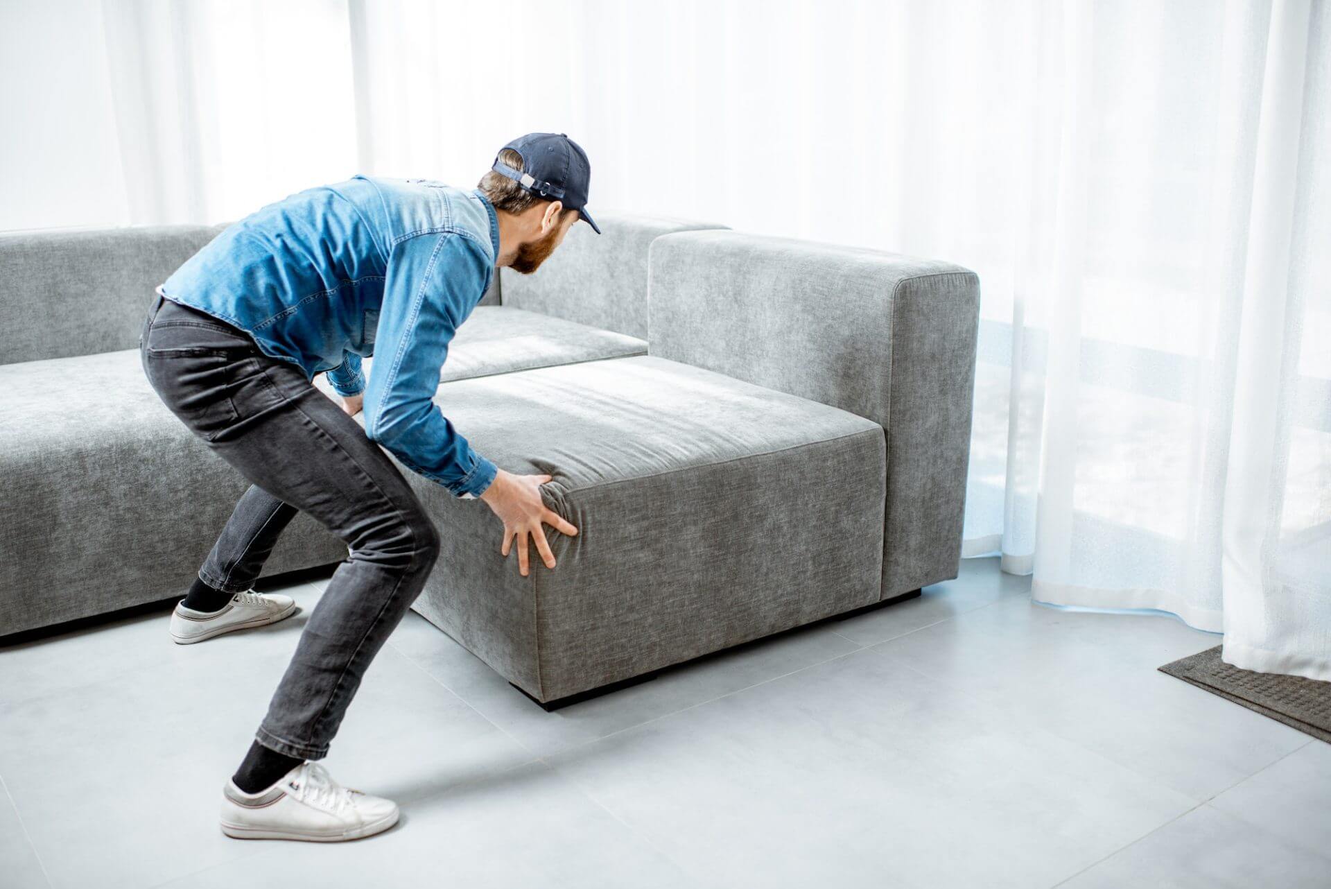 Man mounting couch in the apartment