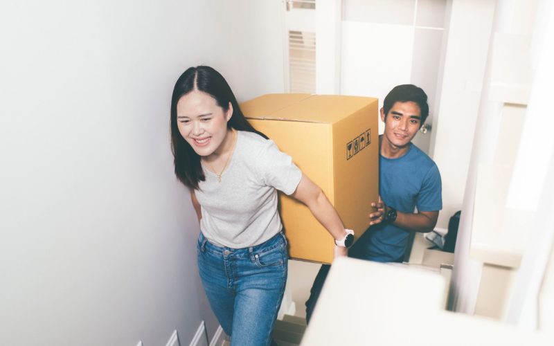 Happy young couple enjoying together moving in a new house. New house at moving day.